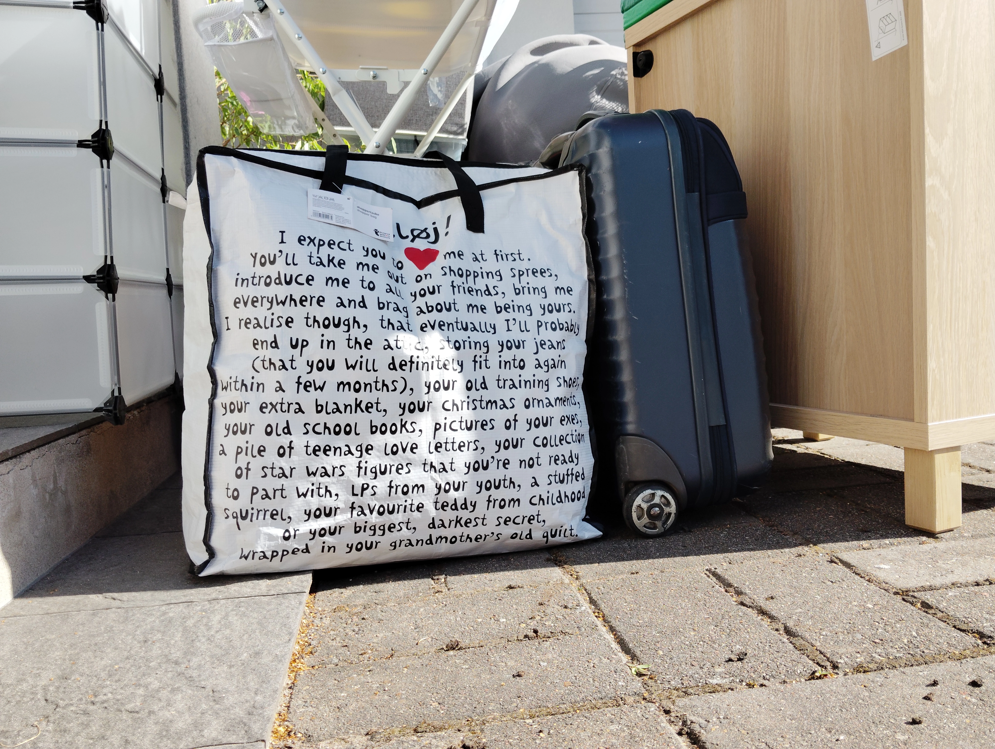Packed moving boxes, luggage and household furniture prepared for an apartment move in Ylöjärvi.